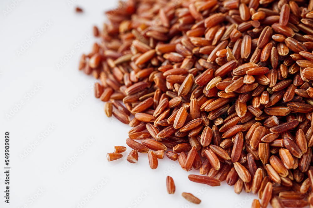 raw fresh red rice on a white background raw fresh red rice on a white background