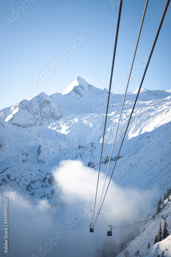 High quality landscape photo of Austrian mountain range with blue sky. Image of mountain peak covered in snow.