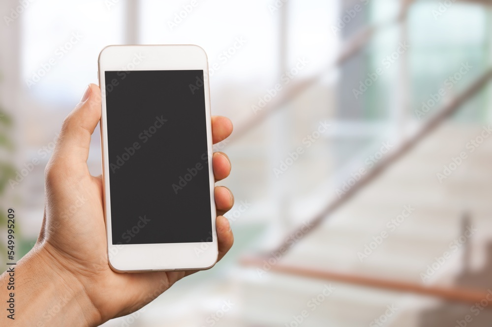 Hand holding modern Smartphone with a blank screen Hand holding modern Smartphone with a blank screen
