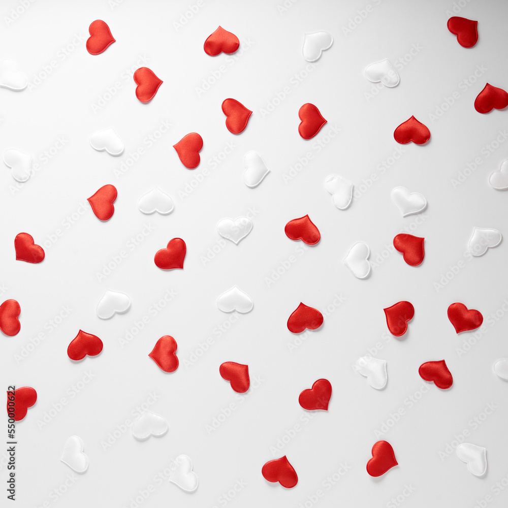 Red and white silk hearts isolated on white background. Valentine's day or Wedding romantic concept, top view, copy space, flat lay