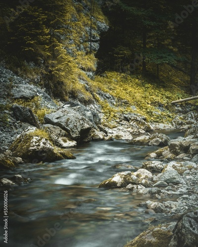 Long exposure of a stream in a Nature reserve in Kvacany, Slovak Republic, with a rocky shore photo