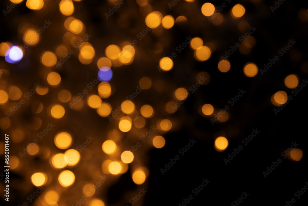 Abstract background of blurred yellow lights for design. Lights bokeh dis focus. Christmas background, copy space