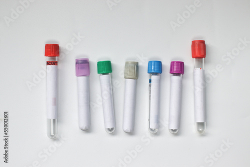 Фотография Empty blood sampling collection tubes of various types on white
