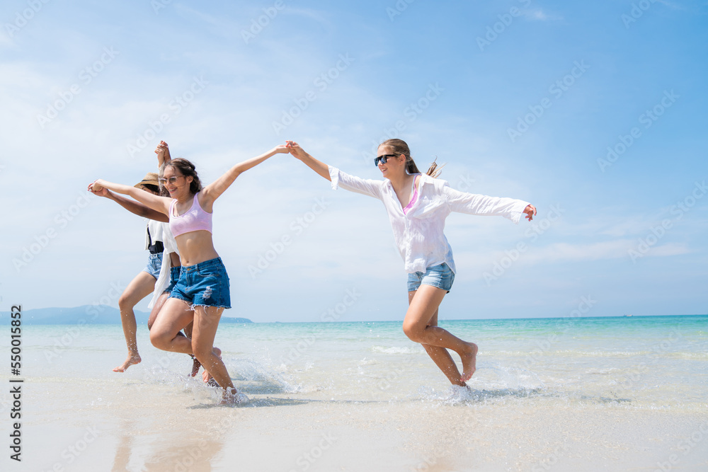 Happy friends at beach party runs together on the beach having fun in a sunny day, Beach summer holiday sea people concept Happy friends at beach party runs together on the beach having fun in a sunny day, Beach summer holiday sea people concept