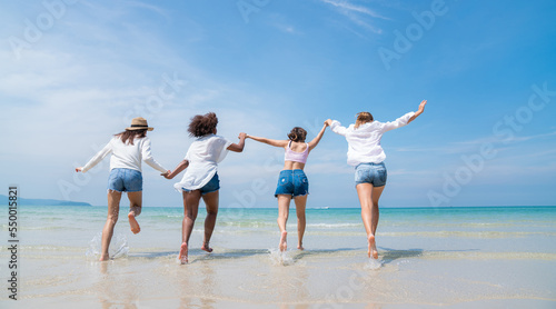 Happy friends at beach party runs together on the beach having fun in a sunny day, Beach summer holiday sea people concept © kelvn