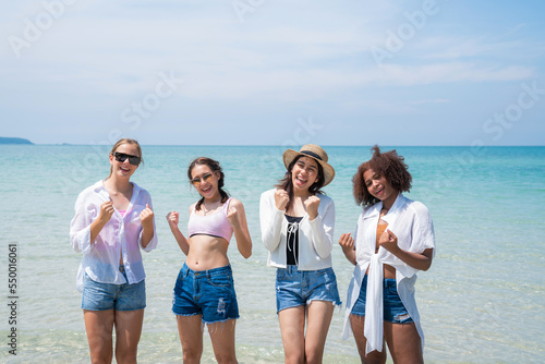 Happy teenagers at beach party together on the beach having fun in a sunny day, Beach summer holiday sea people concept © kelvn
