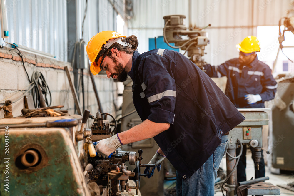 Male technician worker checking and repair pressing metal machine at factory, Machine maintenance technician operation concept. Male technician worker checking and repair pressing metal machine at factory, Machine maintenance technician operation concept.