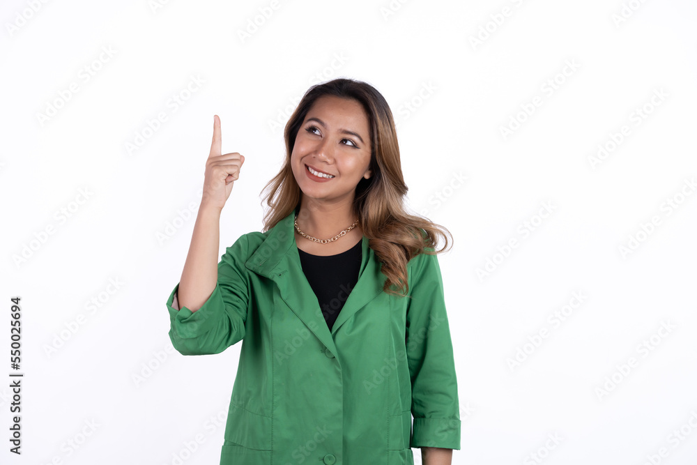 Smiling beautiful Asian woman pointing finger upward to empty space in studio white isolated background. Smiling beautiful Asian woman pointing finger upward to empty space in studio white isolated background.