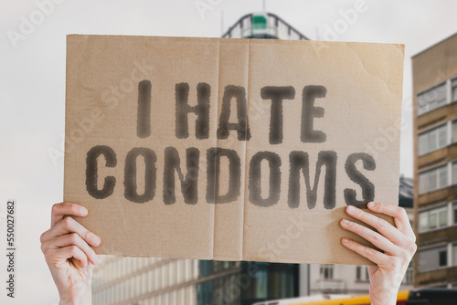 Wallpaper Mural The phrase " I Hate Condoms " is on a banner in men's hands with blurred background. Contraceptive. Control. Education. Health Care. Medical. Medicine. Pregnancy. Prevention. Aids. Health. Care Torontodigital.ca