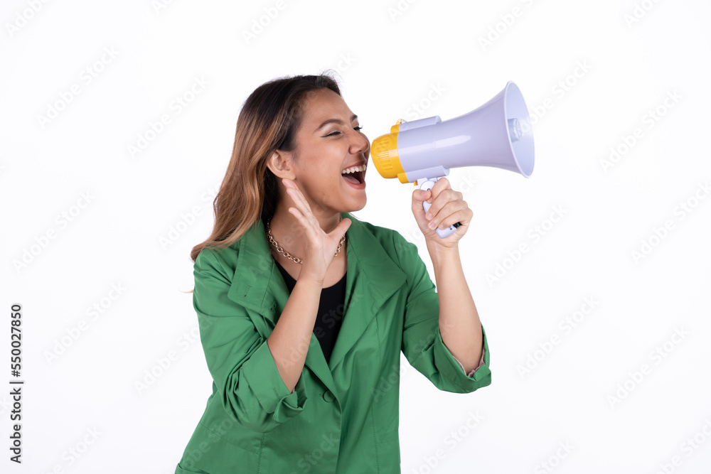 Young asian woman shouts into a megaphone. Isolated white background. Young asian woman shouts into a megaphone. Isolated white background.