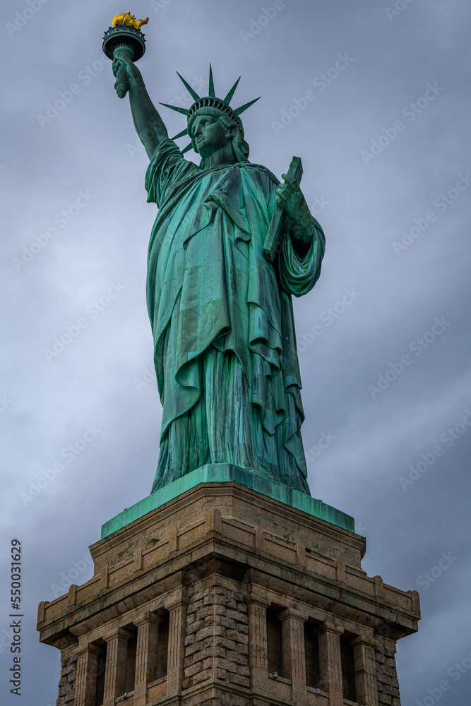 The Statue of Liberty in New York City in a cloudy day.