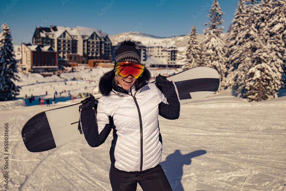 Cheerful girl with snowboard