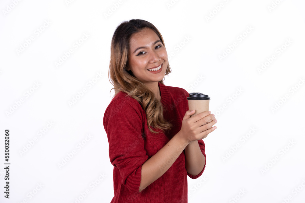 Happy young energetic asian woman smiling, drinking, holding cup mug of coffee, standing confident against white background Happy young energetic asian woman smiling, drinking, holding cup mug of coffee, standing confident against white background