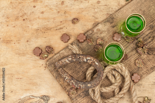 St. Patrick's Day concept. Traditional green cocktail, sweet chocolate in the shape of clover leaves photo