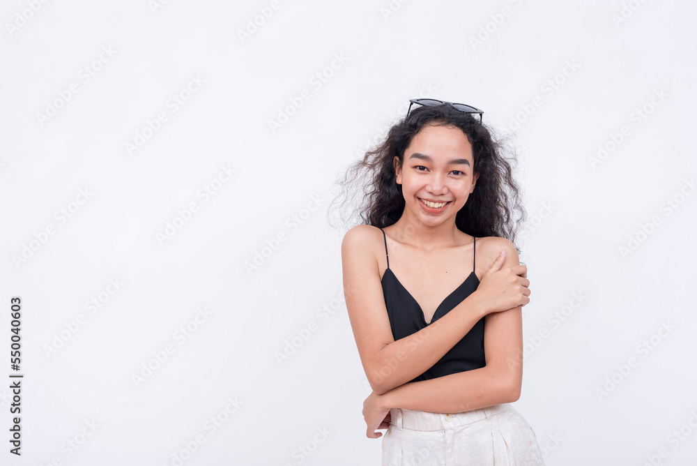 A young woman with her hand on her arm, feeling her soft supple skin, possible skin-care concept. Isolated on a white background. A young woman with her hand on her arm, feeling her soft supple skin, possible skin-care concept. Isolated on a white background.