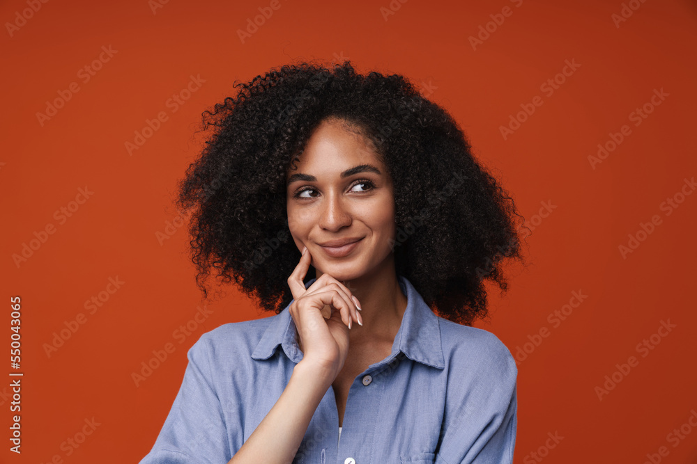 Young middle-eastern woman with curly hair posing with thoughtful look Young middle-eastern woman with curly hair posing with thoughtful look