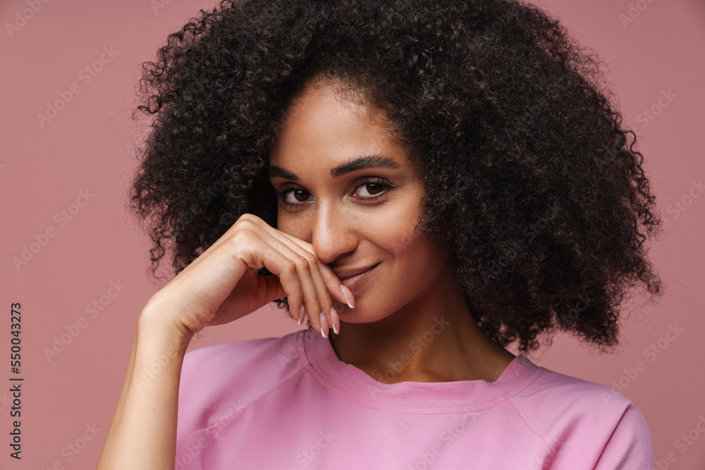 Young middle-eastern woman with curly hair smiling at camera Young middle-eastern woman with curly hair smiling at camera