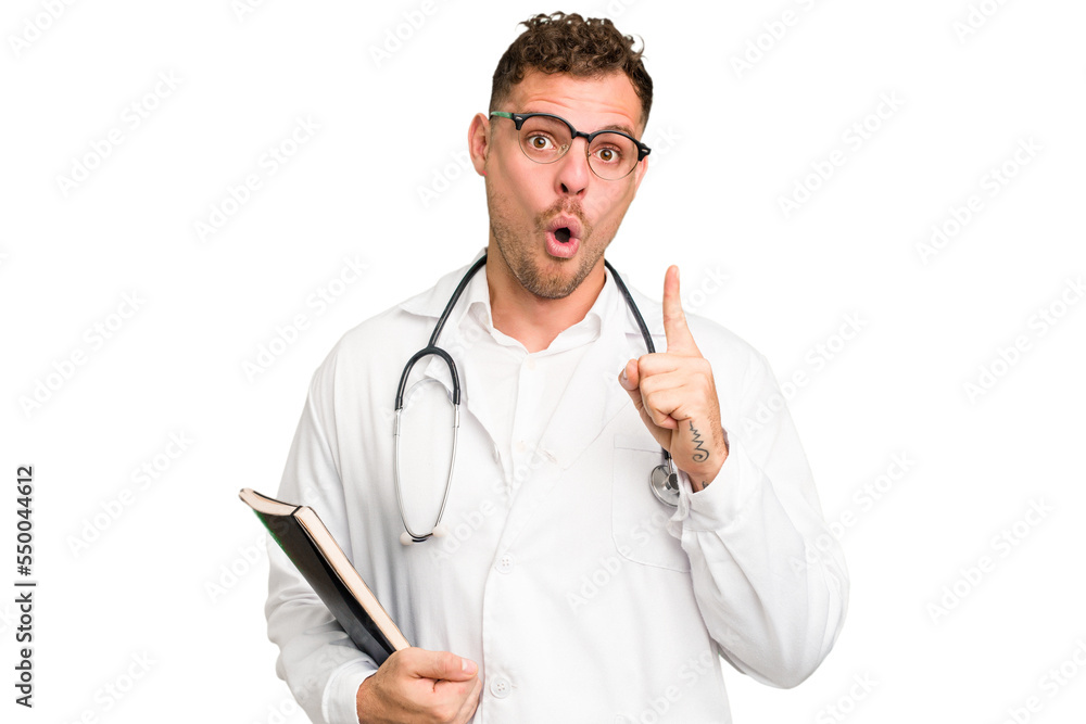 Young doctor caucasian man holding a book isolated having some great idea, concept of creativity. Young doctor caucasian man holding a book isolated having some great idea, concept of creativity.