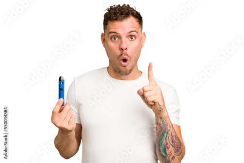 Young caucasian man holding a electronic cigarette isolated having some great idea, concept of creativity.