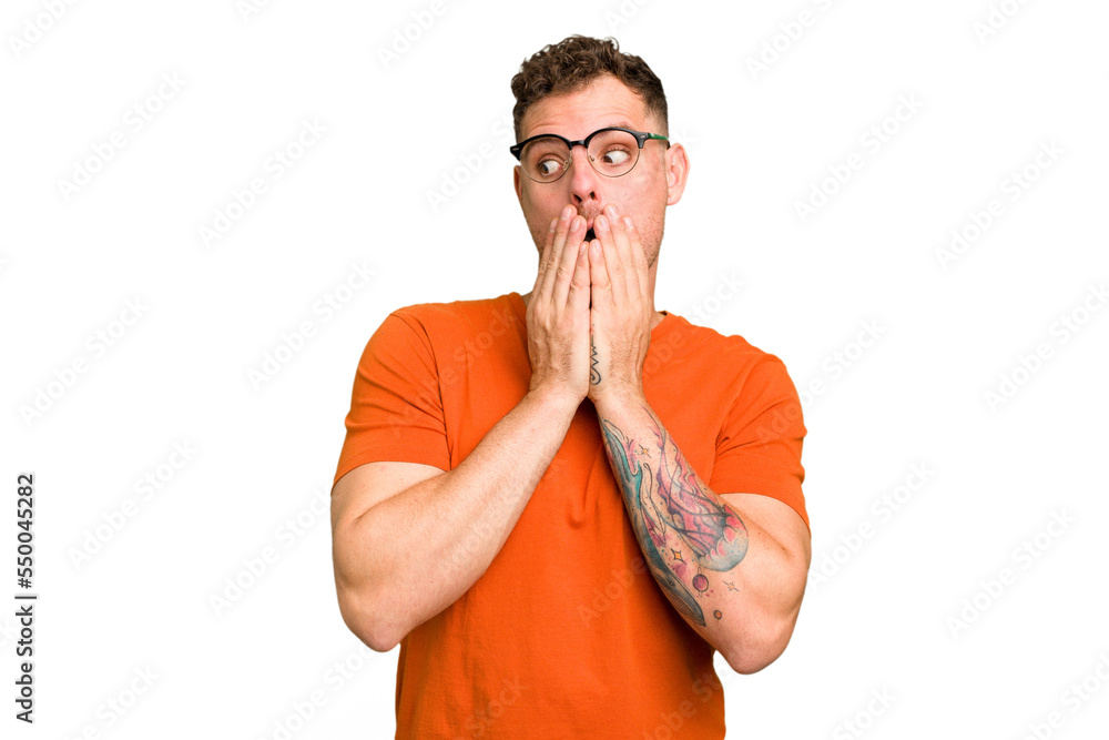 Young caucasian handsome man isolated thoughtful looking to a copy space covering mouth with hand. Young caucasian handsome man isolated thoughtful looking to a copy space covering mouth with hand.