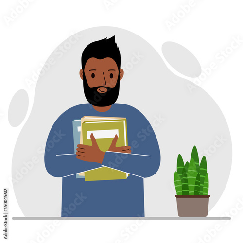 A man holds a stack of books in his hands. Knowledge or education for future work, personal improvement, reading list.