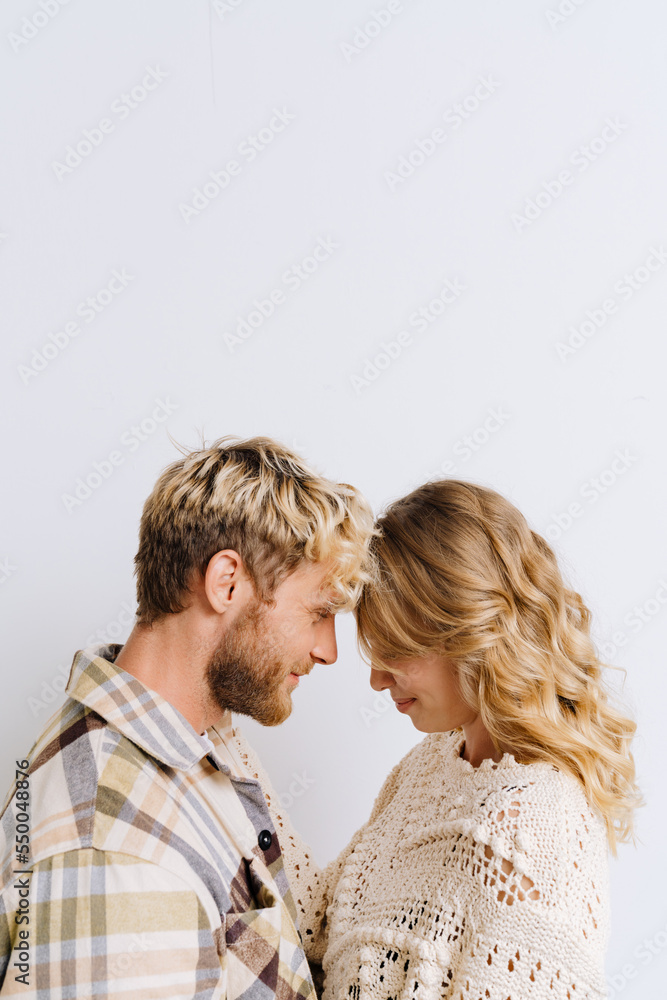 Beautiful couple in love touching foreheads and smiling isolated