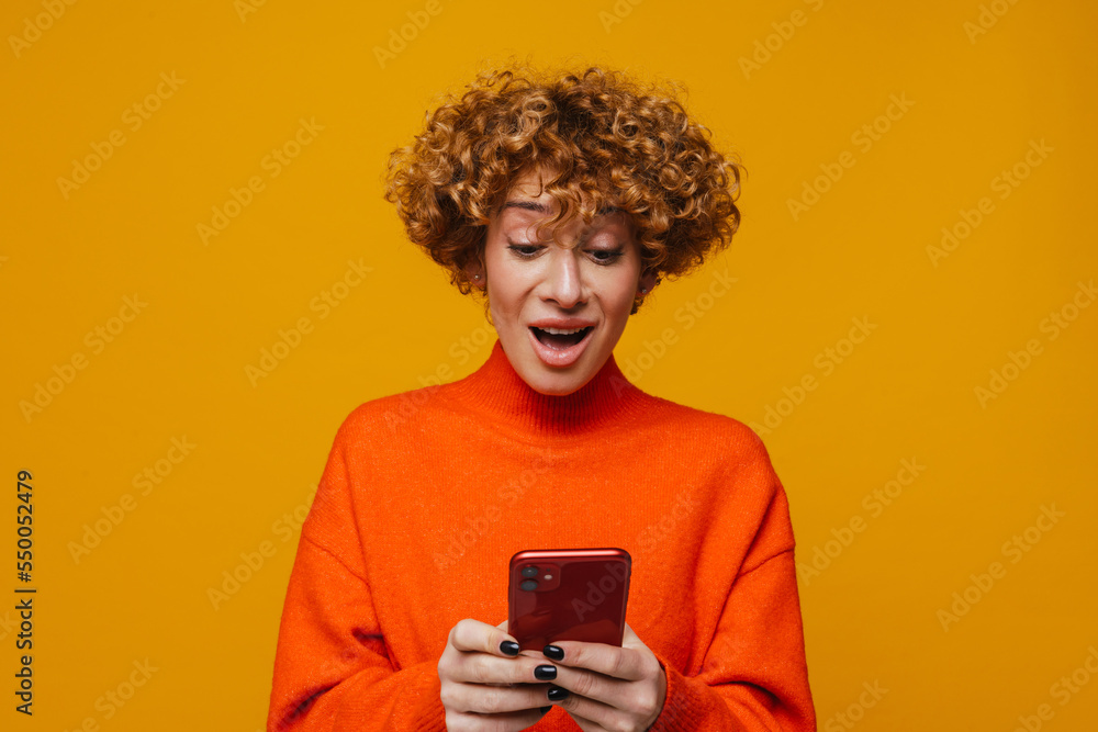 Surprised middle-aged woman using smartphone isolated Surprised middle-aged woman using smartphone isolated