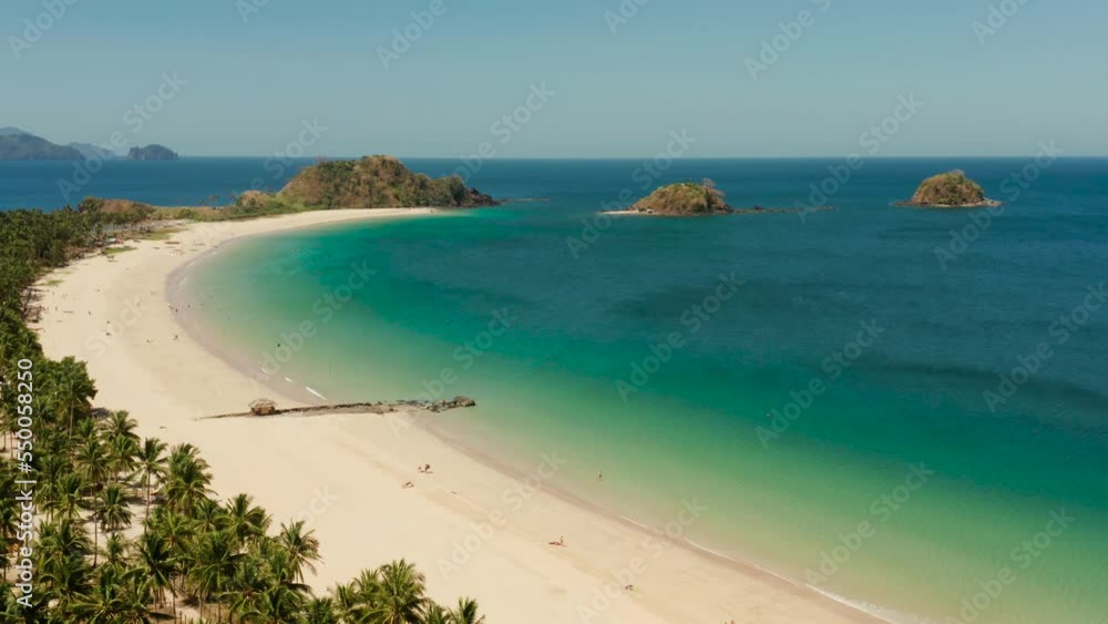 Aerial view of tropical island with sandy beach. Nacpan, El Nido, Palawan, Philippines. Seascape with sea, sand, palm trees. Summer and travel vacation concept Aerial view of tropical island with sandy beach. Nacpan, El Nido, Palawan, Philippines. Seascape with sea, sand, palm trees. Summer and travel vacation concept