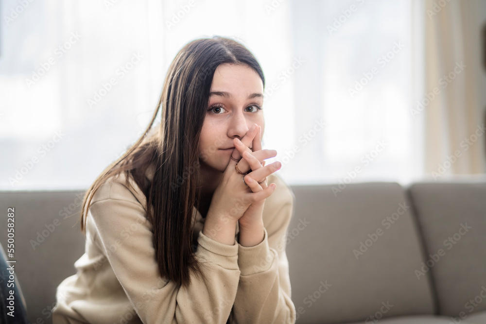 teen sitting on couch at home Frustrated confused female feels unhappy problem in personal life teen sitting on couch at home Frustrated confused female feels unhappy problem in personal life