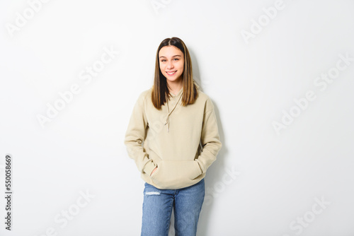 Young brunette woman on studio white background