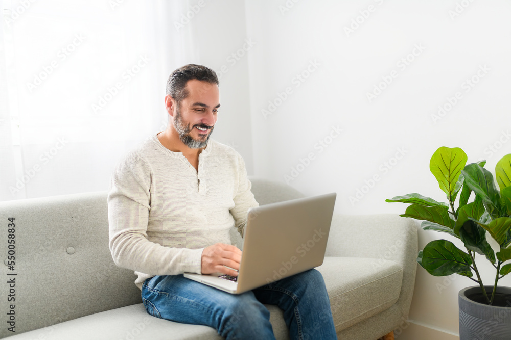 technology, internet, communication and people concept - young man using laptop at home technology, internet, communication and people concept - young man using laptop at home