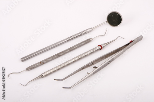 Metal dentist tools against a white background