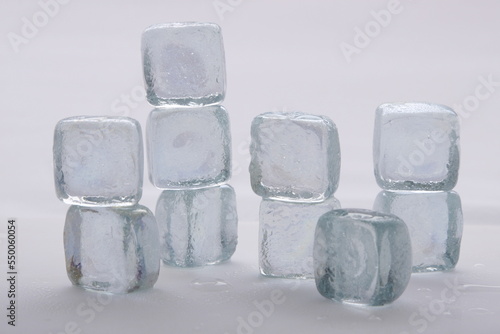 Ice cubes in a stack against a white background