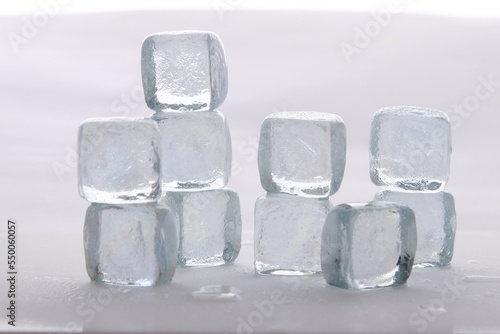 Ice cubes in a stack against a white background