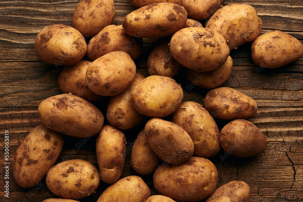 Potatoes on wooden planks food still life background Potatoes on wooden planks food still life background