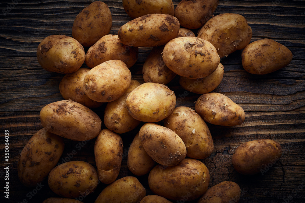 Potatoes on wooden planks food still life background Potatoes on wooden planks food still life background