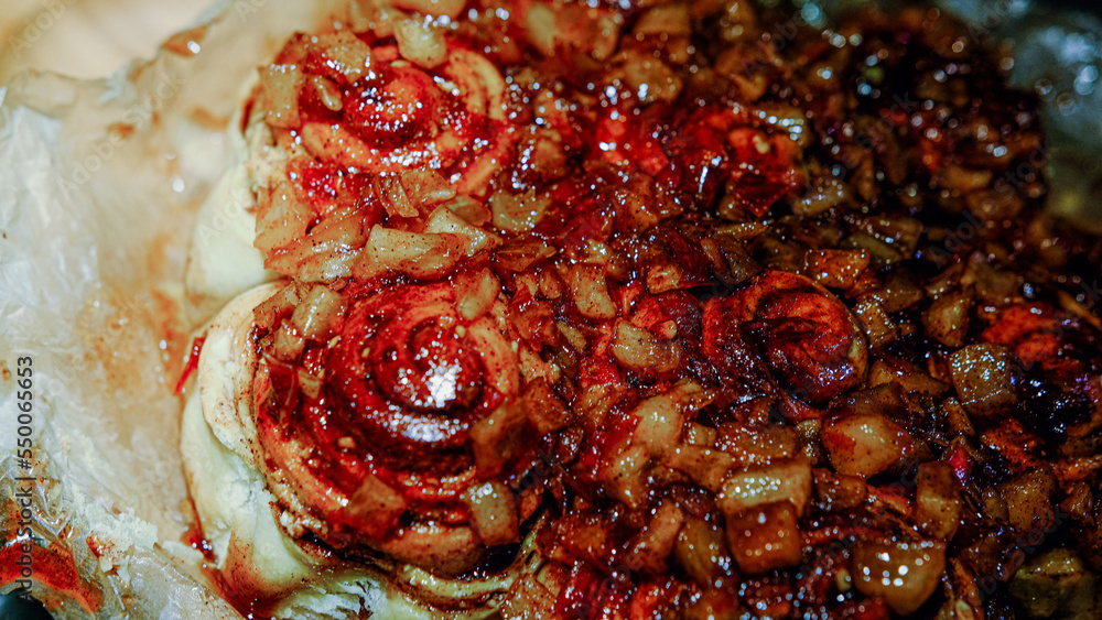 Homemade red tasty apple pie on a dark stove background in parchment butter paper Homemade red tasty apple pie on a dark stove background in parchment butter paper