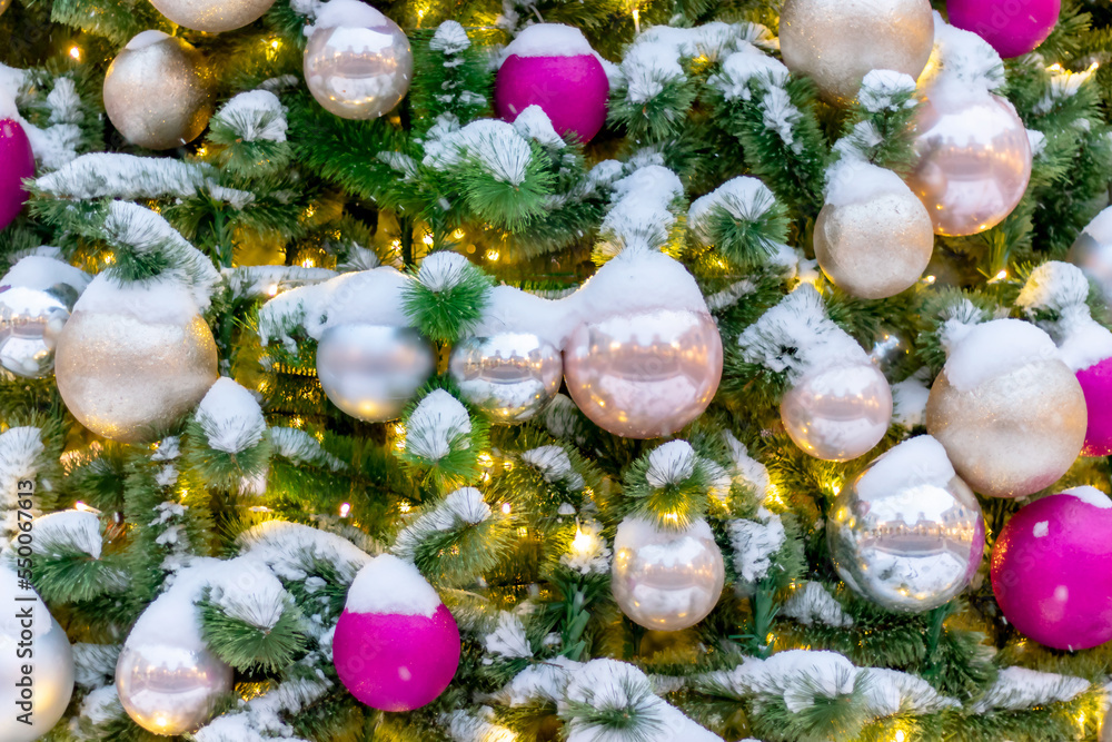 Winter background of Christmas tree toys on the branches of a Christmas tree covered with snow. Close-up. Winter background of Christmas tree toys on the branches of a Christmas tree covered with snow. Close-up.