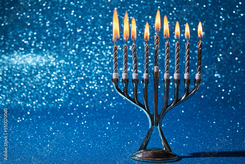 Jewish holiday Hanukkah background with menorah -traditional candelabra and candles