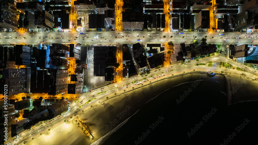 Drone night image of city streets and buildings