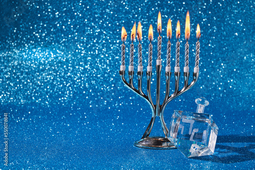 Photography Jewish holiday Hanukkah background with menorah and dreidel with letters Gimel and Nun
