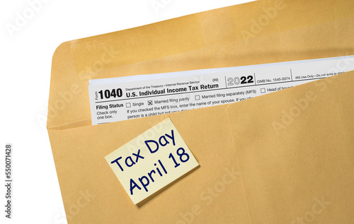 Printed copy of Form 1040 for income tax return for 2022 with reminder for April 18 2023 deadline photo