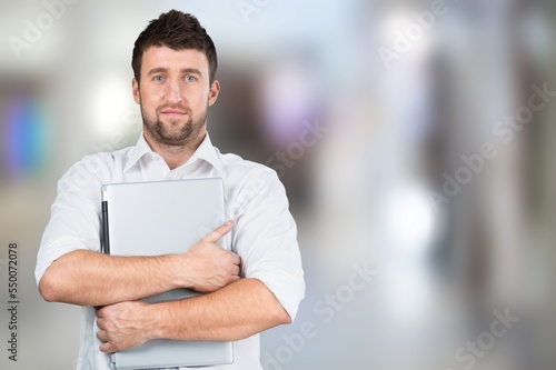 Happy young business man with laptop computer
