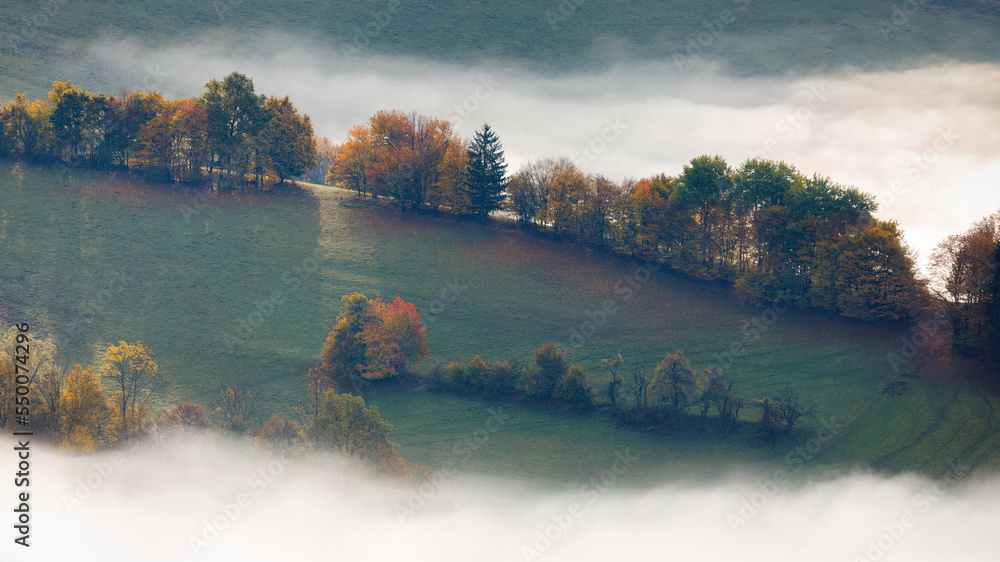 Landscape of foggy valley in an autumn morning. The Sulov Rocks, national nature reserve in northwest of Slovakia, Europe.