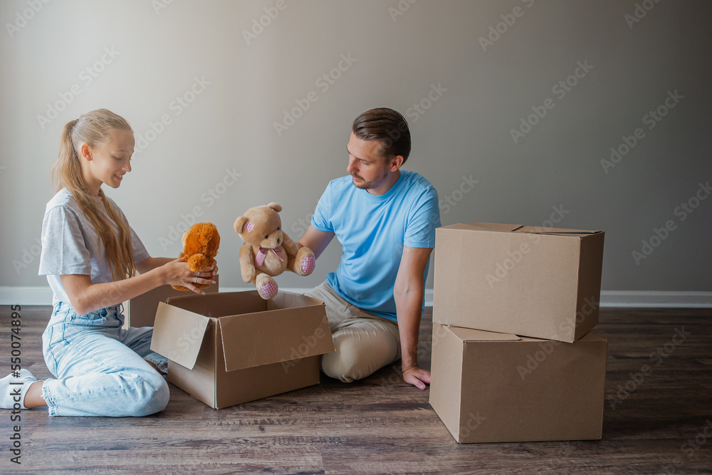 Happy father with daughter have fun in their new home. Family enjoy their moving day Happy father with daughter have fun in their new home. Family enjoy their moving day