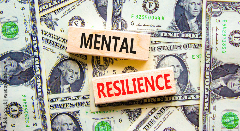 Mental resilience symbol. Concept word Mental resilience typed on wooden blocks. Beautiful background from dollar bills. Business psychological and mental resilience concept. Copy space.