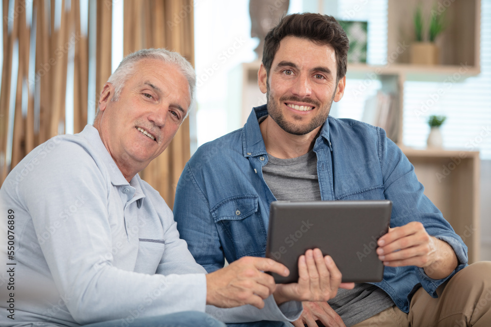 senior father and young son with tablet senior father and young son with tablet