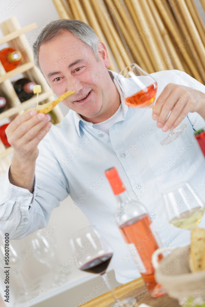 man holding rose wine and cheese man holding rose wine and cheese