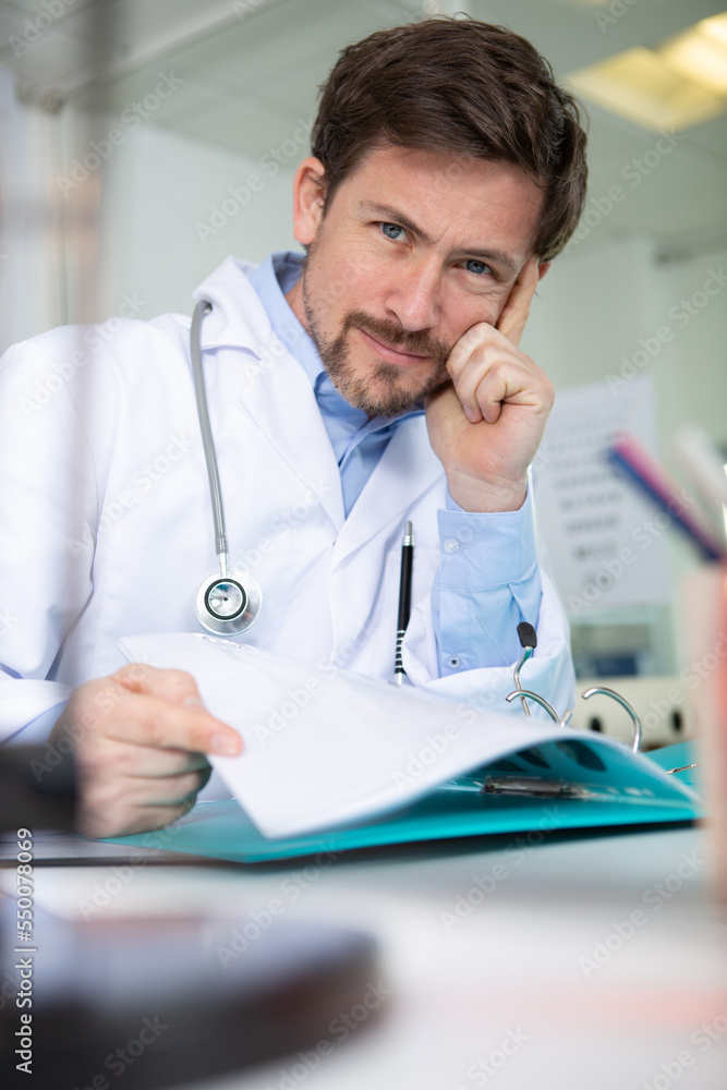 handsome doctor overthinking in his office handsome doctor overthinking in his office
