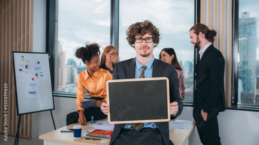 Portrait of happy Business holding Blank chalkboard and people converse during a meeting about papers and concepts. Portrait of happy Business holding Blank chalkboard and people converse during a meeting about papers and concepts.